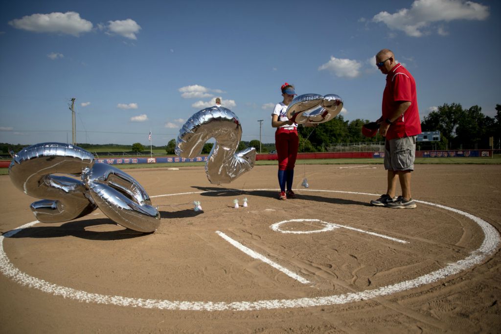 First Place, Sports Picture Story - Jessica Phelps / Newark Advocate, “The Season That Almost Was”Lakewood senior, Laila Schmitt wrestles with balloons that spell out 2020 for their senior night they had  June 30. Their season was canceled but OHSAA regulations allowed teams to cobble together a makeshift summer season to let kids play with their teams. Lakewood senior night was a family affair and saw the JV team take on varsity players.